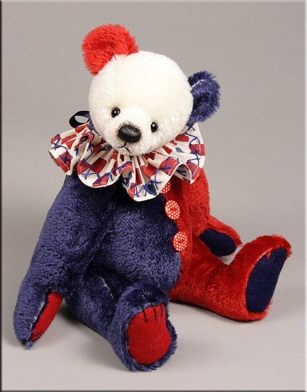a photo of a teddy clown plushie
